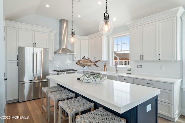 324 3rd St, Beach Haven, NJ 08008 - kitchen featuring high end fridge, wall chimney exhaust hood, lofted ceiling, a kitchen island, and a sink