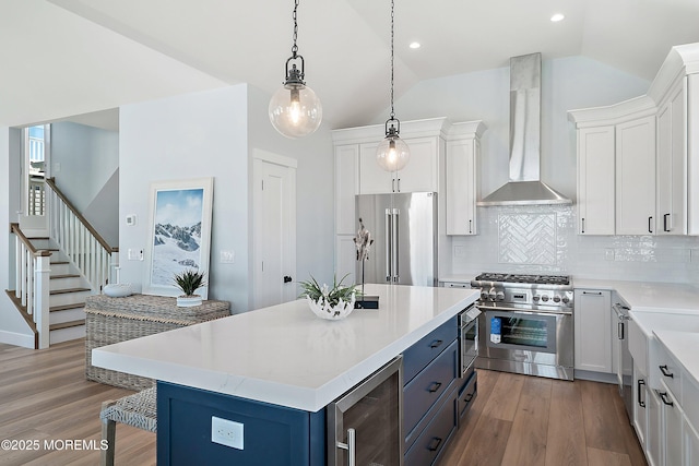 324 3rd St, Beach Haven, NJ 08008 - kitchen featuring high quality appliances, wall chimney range hood, vaulted ceiling, beverage cooler, and light countertops