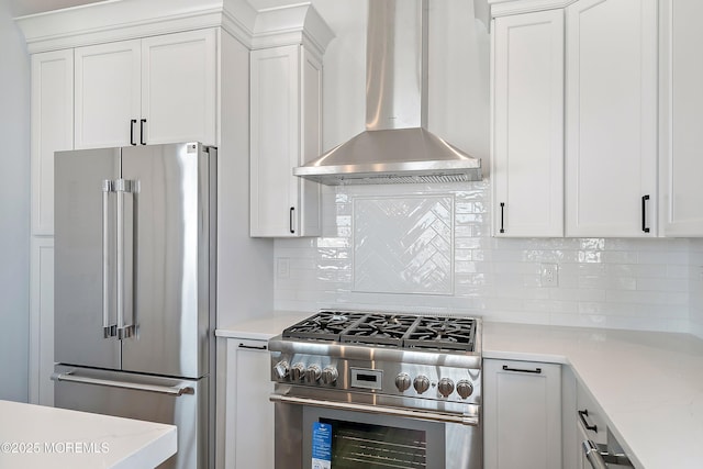 324 3rd St, Beach Haven, NJ 08008 - kitchen featuring high end appliances, island exhaust hood, white cabinetry, tasteful backsplash, and light stone countertops