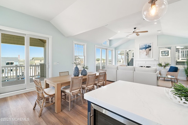 324 3rd St, Beach Haven, NJ 08008 - dining room with lofted ceiling, healthy amount of natural light, light wood-type flooring, a fireplace, and ceiling fan