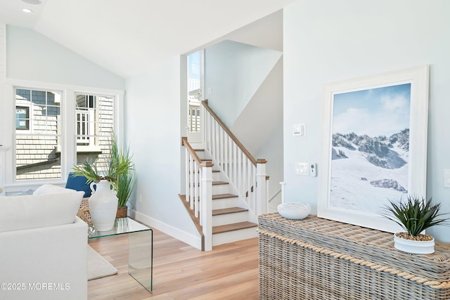 324 3rd St, Beach Haven, NJ 08008 - staircase with wood finished floors, vaulted ceiling, and baseboards