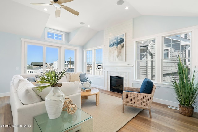 324 3rd St, Beach Haven, NJ 08008 - living area featuring vaulted ceiling, baseboards, light wood-style flooring, ceiling fan, and a glass covered fireplace