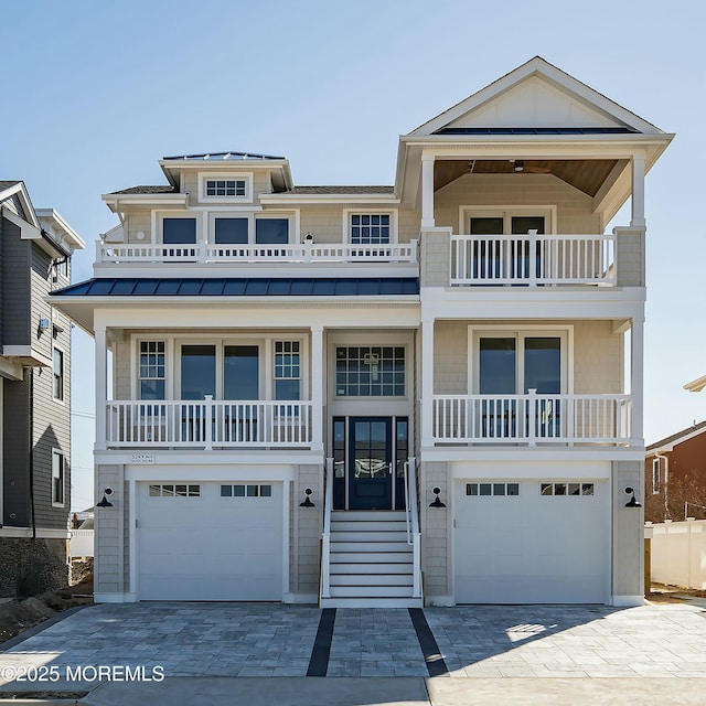 324 3rd St, Beach Haven, NJ 08008 - coastal home with a balcony, an attached garage, and decorative driveway