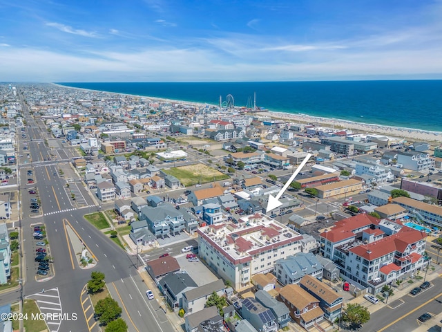 aerial view with a water view and a view of the beach