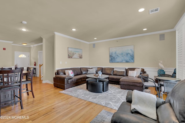 living room with ornamental molding and light wood-type flooring