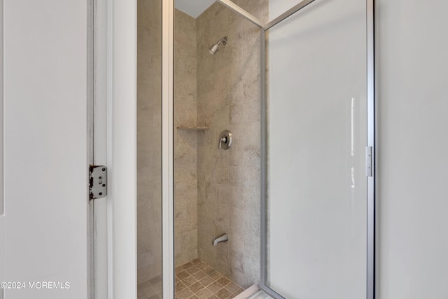 bathroom featuring a shower with door