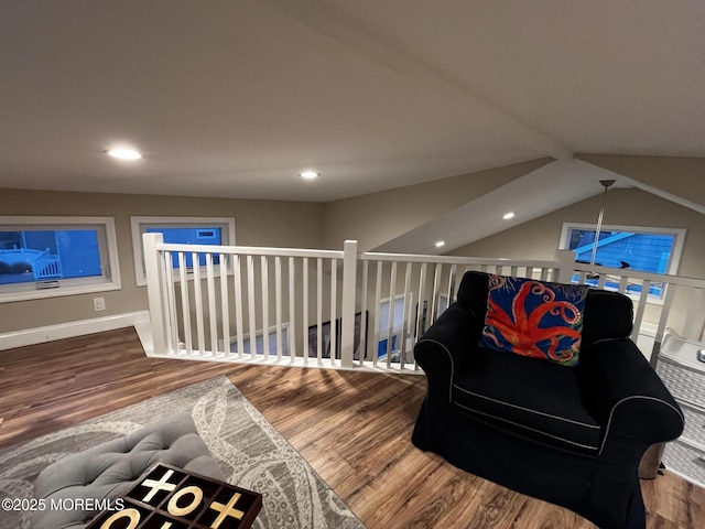 sitting room with hardwood / wood-style flooring and vaulted ceiling