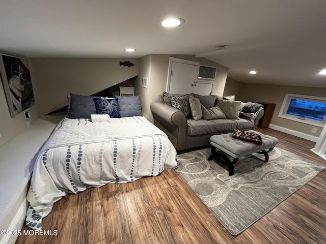 bedroom featuring wood-type flooring and vaulted ceiling