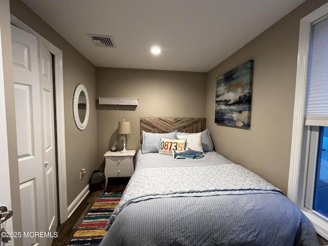 bedroom with dark hardwood / wood-style floors