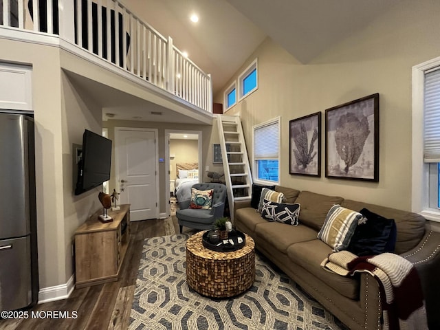 living room with dark hardwood / wood-style flooring and a towering ceiling