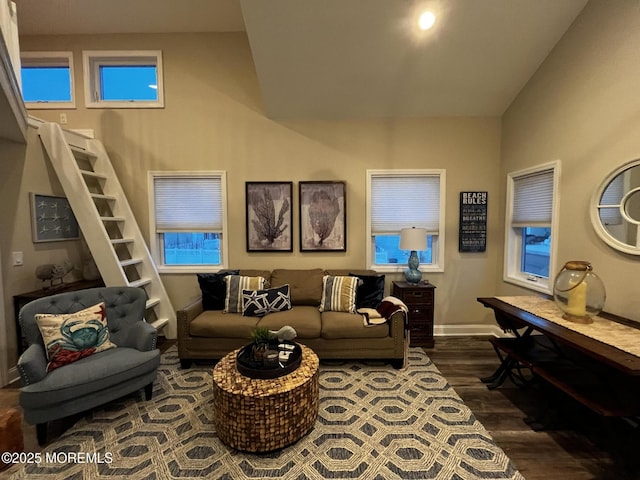 living room featuring lofted ceiling and dark hardwood / wood-style floors