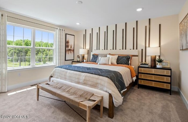 carpeted bedroom featuring multiple windows