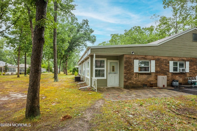 exterior space featuring a patio and a front lawn