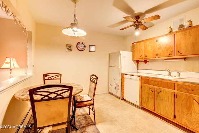 kitchen featuring pendant lighting, sink, white appliances, ceiling fan, and backsplash