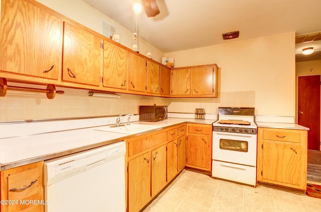 kitchen with tasteful backsplash, white appliances, and sink