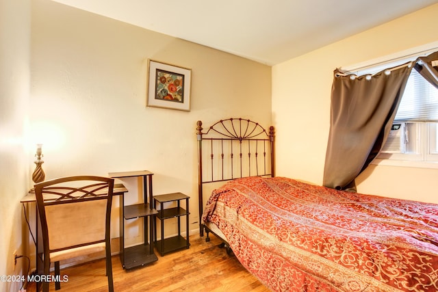 bedroom featuring cooling unit and wood-type flooring