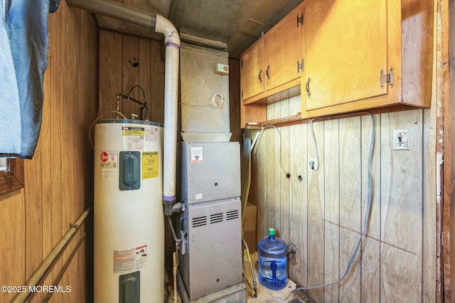 utility room featuring water heater