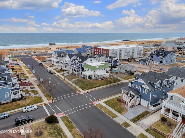 bird's eye view featuring a beach view and a water view