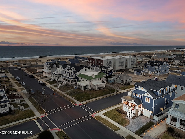 aerial view at dusk with a water view