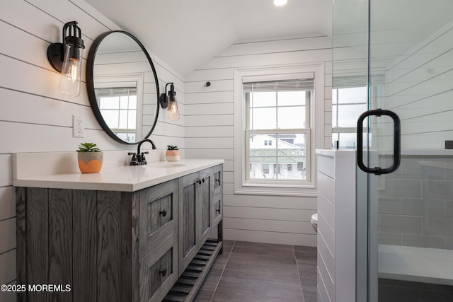 bathroom featuring vanity, tile patterned floors, lofted ceiling, and toilet