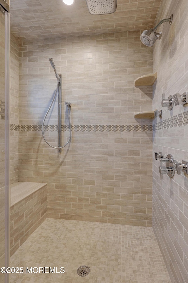 bathroom with a tile shower