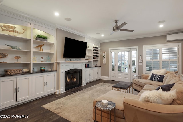 living room with crown molding, dark wood-type flooring, a wall unit AC, and ceiling fan