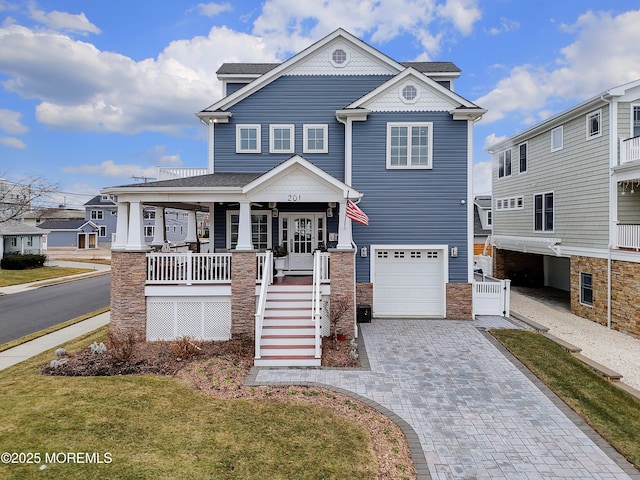 view of front of property featuring a garage and covered porch