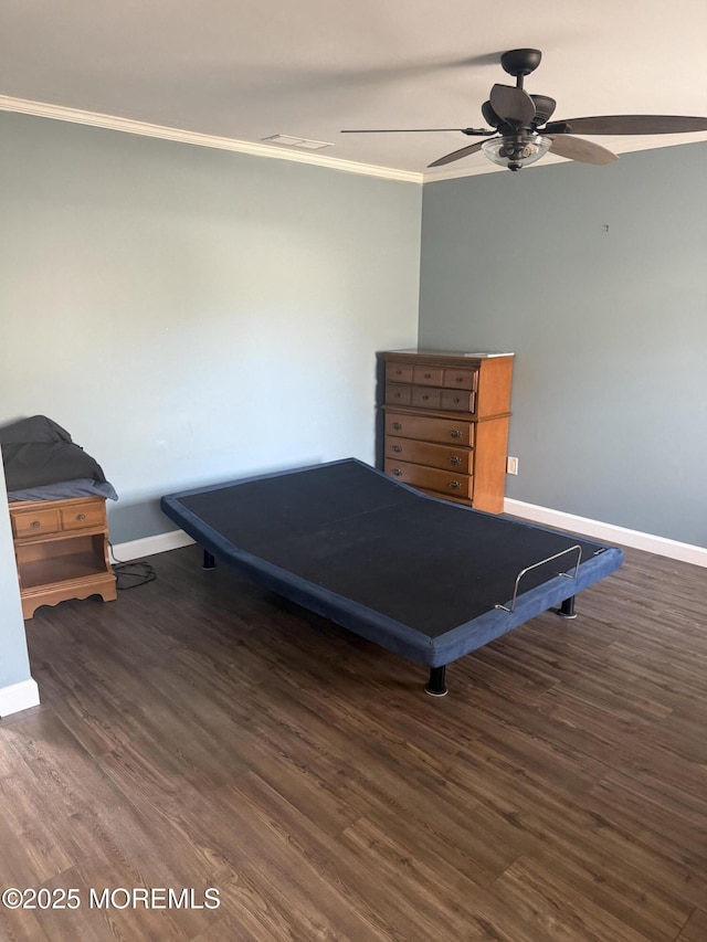 bedroom featuring ornamental molding, dark hardwood / wood-style floors, and ceiling fan