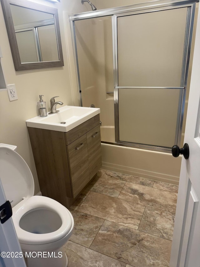 bathroom featuring vanity and bath / shower combo with glass door