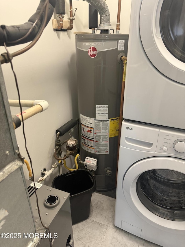 washroom with stacked washer and dryer, water heater, and light tile patterned floors