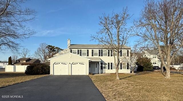 view of front facade featuring a garage and a front yard