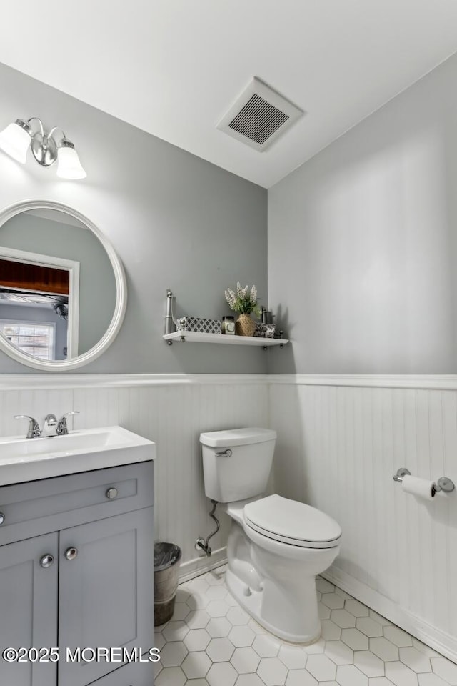 bathroom with vanity, tile patterned floors, and toilet