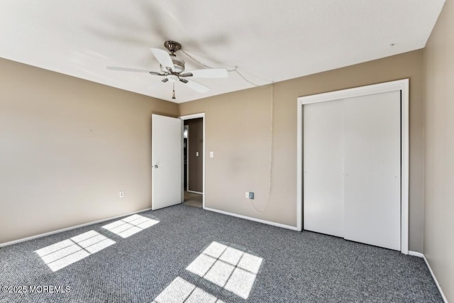 unfurnished bedroom with ceiling fan, dark carpet, and a closet