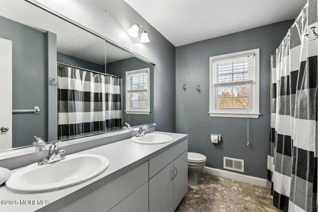 bathroom with vanity, plenty of natural light, and toilet