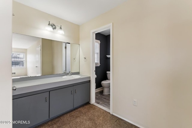 bathroom featuring vanity and toilet