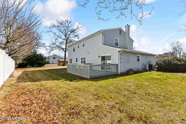 rear view of house featuring a yard and central air condition unit