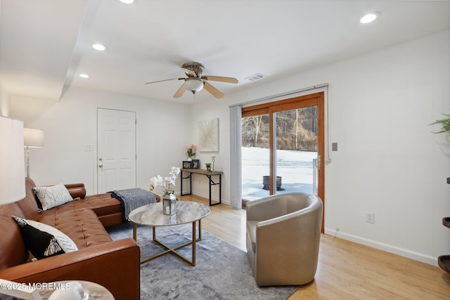 living room with ceiling fan and light hardwood / wood-style flooring