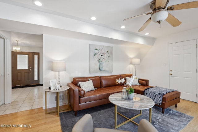 living room featuring light hardwood / wood-style flooring and ceiling fan