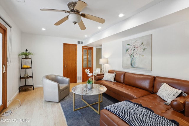 living room with ceiling fan and light hardwood / wood-style floors