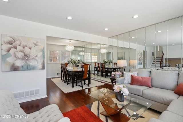 living room with dark hardwood / wood-style floors and a chandelier