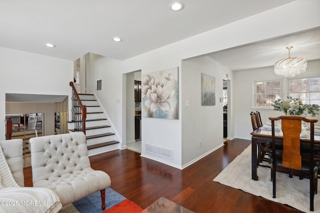 interior space featuring dark hardwood / wood-style floors and a notable chandelier