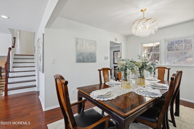 dining area with dark wood-type flooring and a chandelier