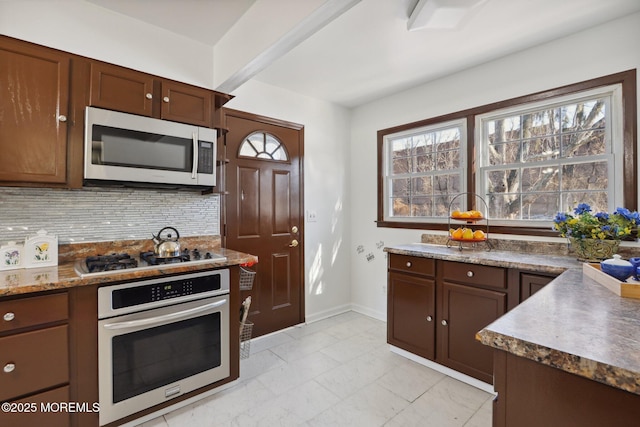 kitchen featuring stainless steel appliances and decorative backsplash