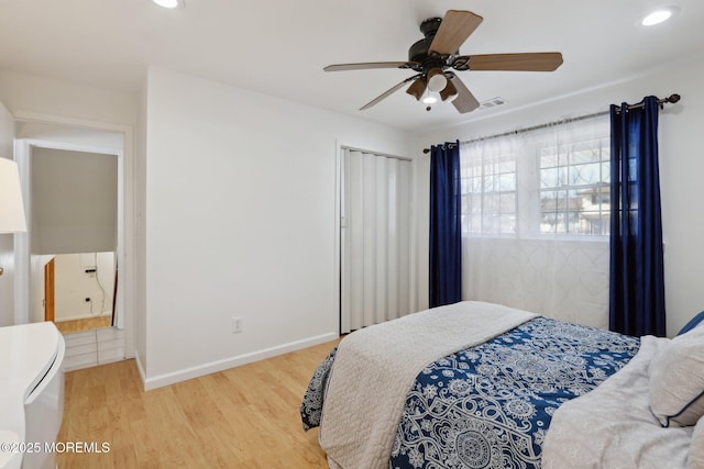 bedroom with ceiling fan and light wood-type flooring