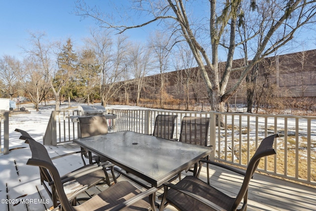 snow covered deck featuring grilling area and a mountain view