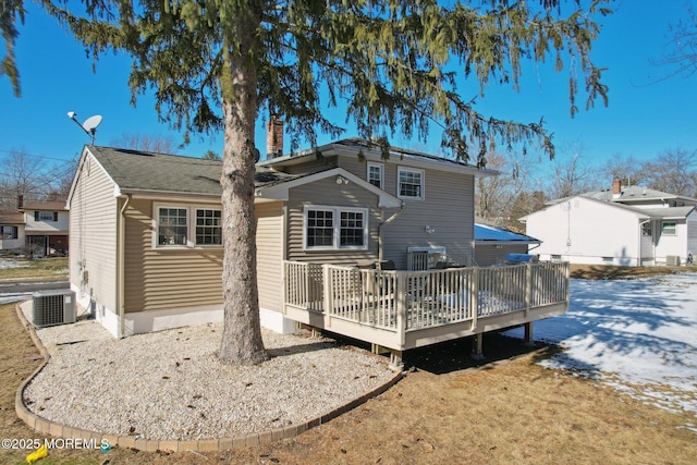 rear view of house with a wooden deck and central AC