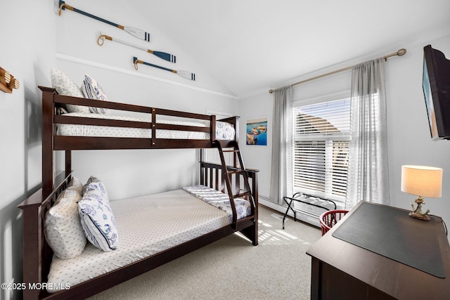 bedroom featuring vaulted ceiling, light colored carpet, and a baseboard radiator