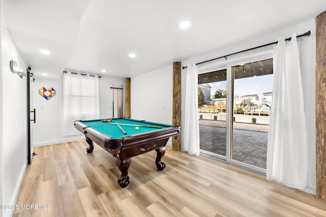 rec room with billiards, light hardwood / wood-style floors, and a barn door