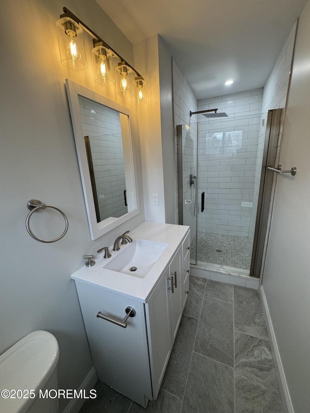 bathroom with vanity, toilet, and walk in shower