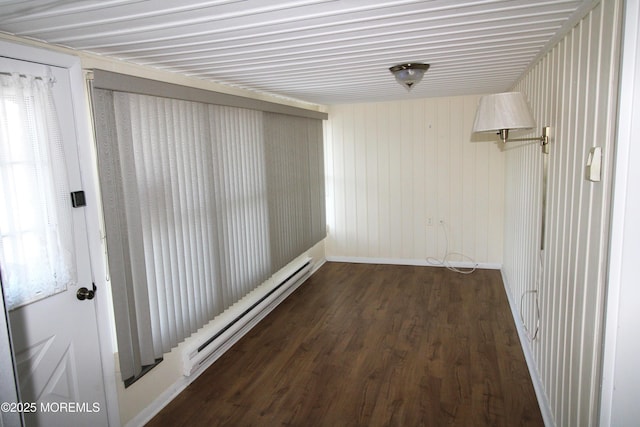 hall with dark wood-type flooring and a baseboard heating unit